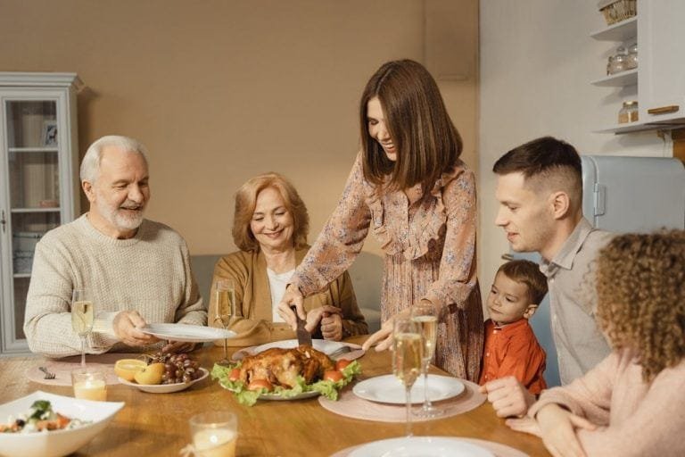 family cutting chicken