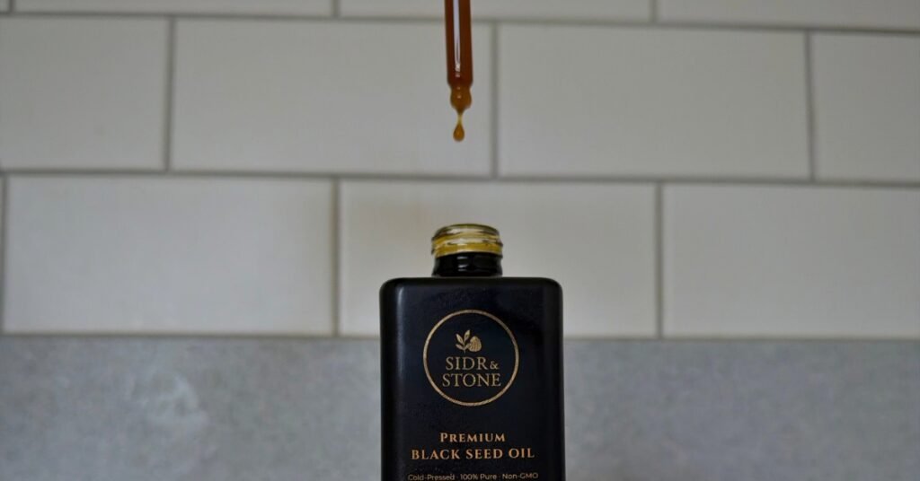 What are the 10 benefits of black seed oil proven by science. a black seed oil bottle
