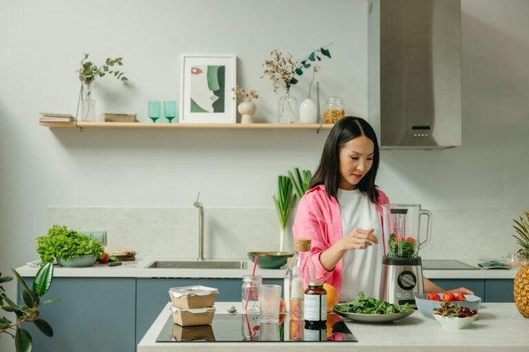 woman in her 40s preparing healthy smoothie with moringa